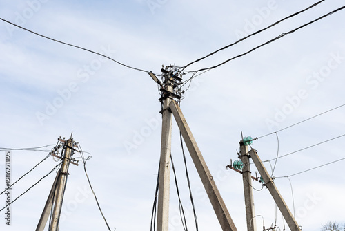 Several utility supports intertwined with intersecting wires and insulator fittings