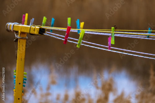 Colorful clothes pegs hanging on a laundry line