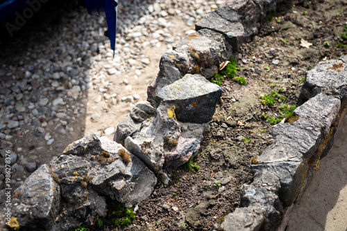 Stone pathways with moss accents. Mosscovered rocks outlining charming rustic garden path