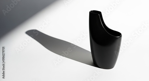 Minimalist black vase object with long shadow on white background