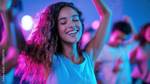 A young woman dancing joyfully at a vibrant party with colorful lights