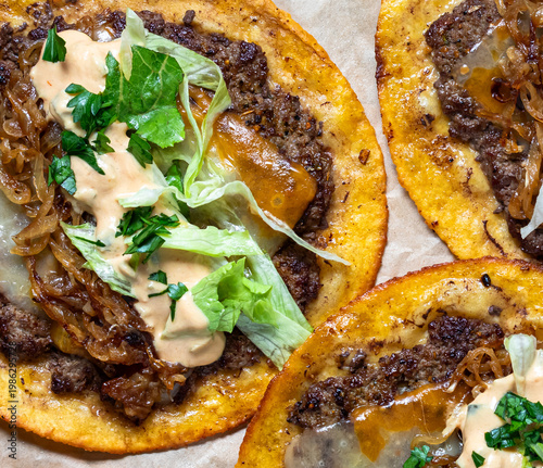 Top down close up look at delicious smash burger tacos with all the fillings.