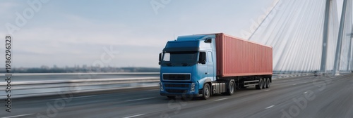 Blue truck with red container driving along cable stayed bridge at dawn highway freight transport cargo logistics in motion scenic panorama