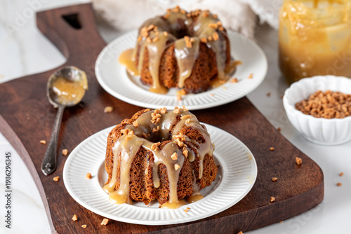 Servings of delicious sticky toffee pudding with caramel sauce and toffee bits.