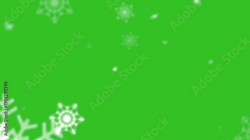A video showcasing white snowflakes gently falling on a vibrant green background
