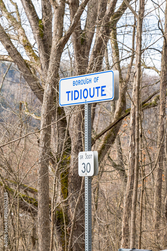 Borough of Tidioute roadside sign with SR 3007 marker in wooded rural Pennsylvania setting, showcasing small-town identity and local travel destination.
