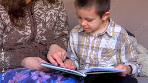 Mother and Young Boy Reading Picture Book Together Pointing at Page — Parent Child Literacy Bonding Early Education and Family Concept