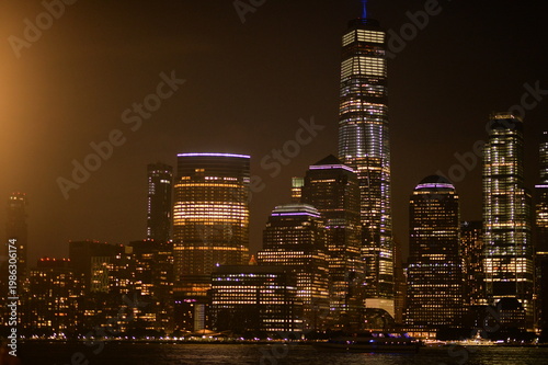 Serene Evening Scene Showcasing Lit Skyscrapers Reflected Beautifully On Quiet River Waters.New York