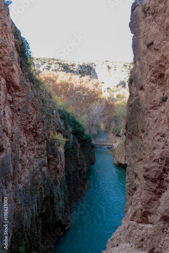 Deep canyon river flowing between towering rock walls