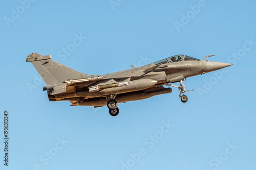 Tableau sur toile Military fighter jet landing with its landing gear deployed.