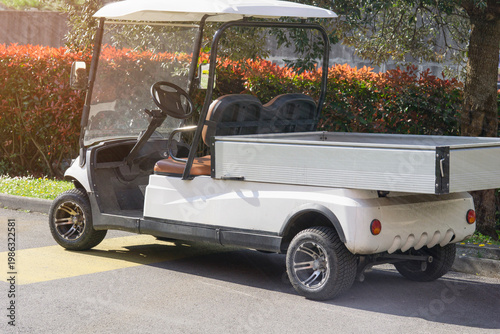 Photos utility golf cart electric vehicle white metal cargo truck parked on asphalt str