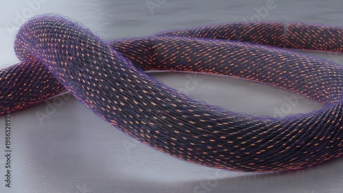 coiled purple rope with multicolored threads on gray surface