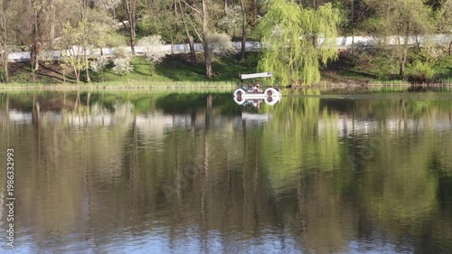 A young couple is rowing across the lake in a rowboat