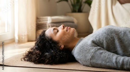 A peaceful close-up lifestyle photo of a beautiful woman meditating in Savasana pose