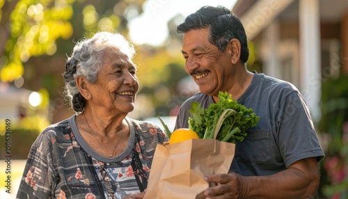 Caring son helps elderly mother with groceries outdoors.