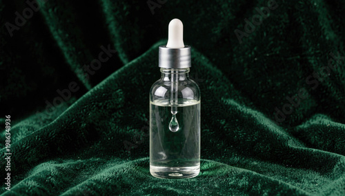 A small glass bottle containing a single drop of liquid