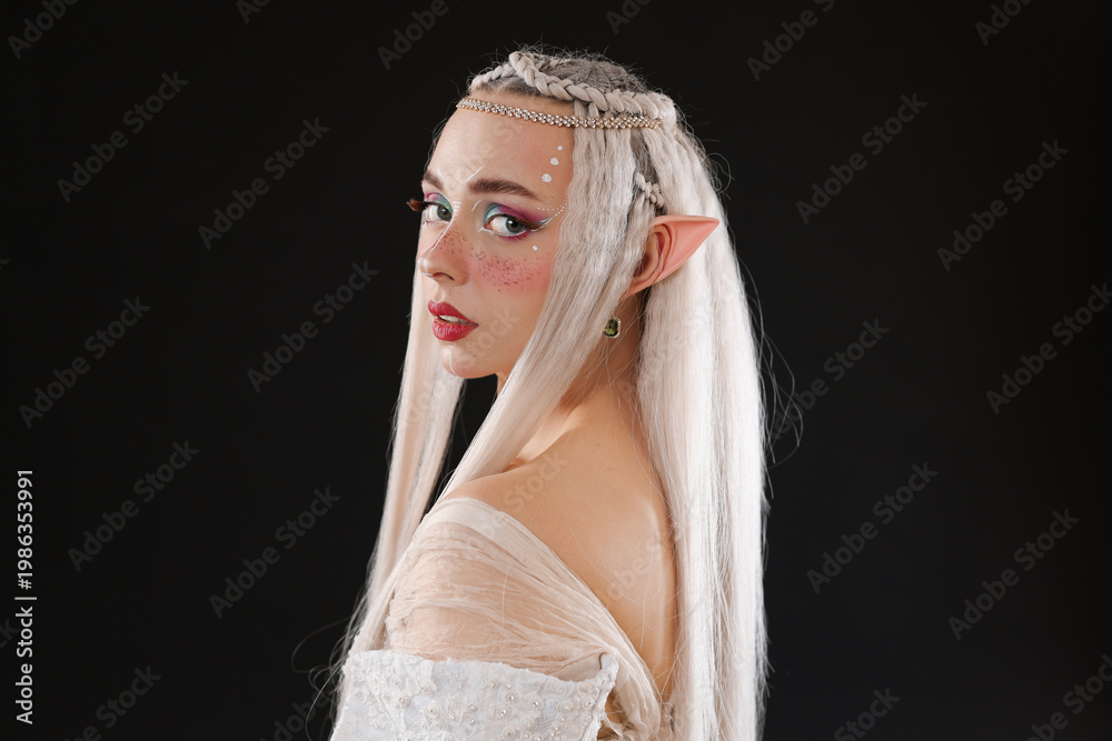 Fototapeta premium Portrait of beautiful elf girl on black background