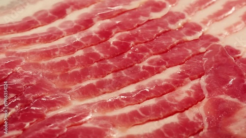  Sliced ham jamon fat bacon meat, beef pastrami thick pieces on a wooden board, beef or pork jamon. Chef cooking breakfast, smoked bacon in cafe. 