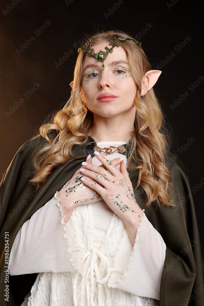 Naklejka premium Beautiful girl dressed as elf on dark background
