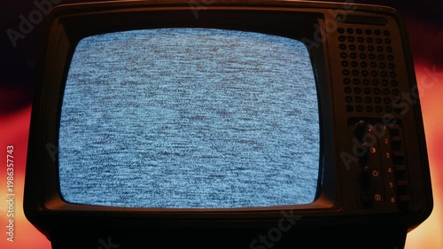 Retro TV, vintage television In a nostalgic setup, a retro TV displays grain on screen, scary halloween night device good for chroma key and green screen.