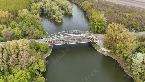 Aerial view of bridge over river oxbow with lush green landscape