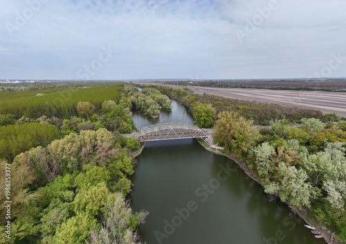 Aerial view of bridge over river oxbow with lush green landscape