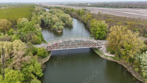 Aerial view of bridge over river oxbow with lush green landscape