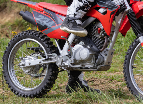 Φωτογραφία Off-road motorcycle on grass field in natural environment