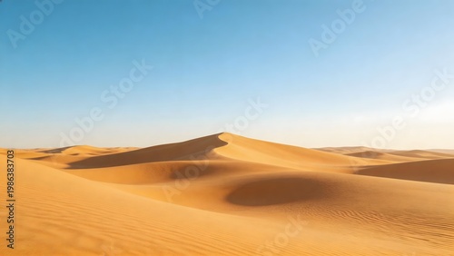 Desert sand dunes under clear sky