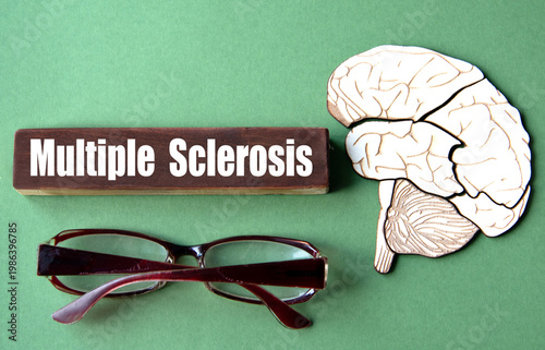 The word MULTIPLE SCLEROSIS is written on wooden cubes against a green background with an image of a skull and brain.