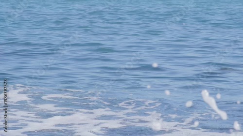 Atlantic Ocean waves crash gently on shore, warm Gulf Stream current, relaxing coastal scene, natural power, sea breeze, aquatic travel