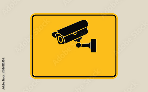 A security camera sign shows a surveillance camera on a yellow background.