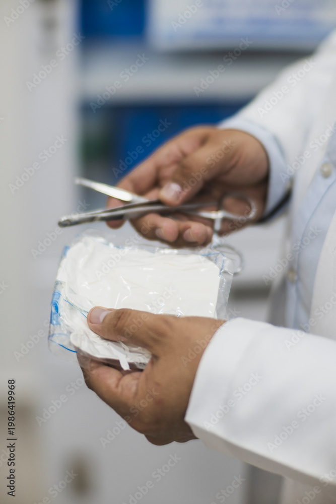 Fototapeta premium Doctor uncovering his latex gloves to use them