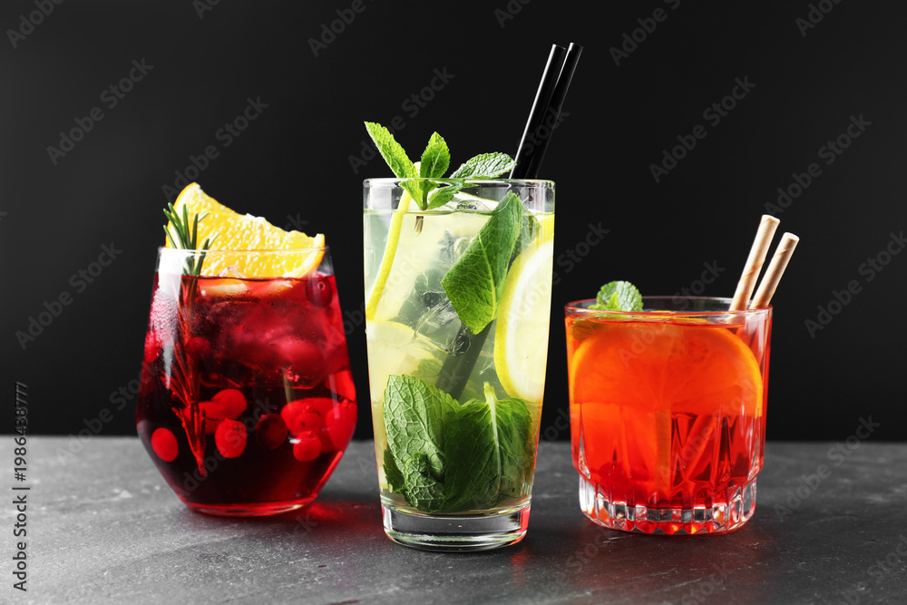 Fototapeta premium Different tasty refreshing cocktails on grey table