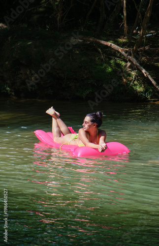 Young Woman Floating Down River