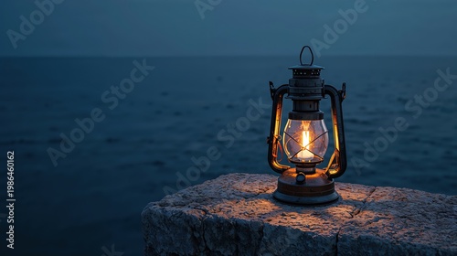 Lantern on a stone with sea in the background at night