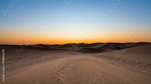 Desert landscape with sand dunes at twilight under a clear sky, no people