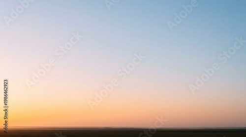 Soft gradient sky at sunset over a dark horizon with sky colors, gradient