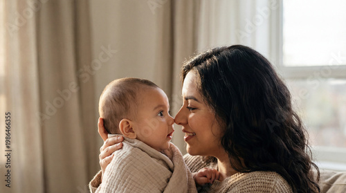 Mothers Day Latina mom holding baby closeup eye contact showing maternal love tenderness connection perfect for celebration greeting card magazine cover editorial commercial content materials
