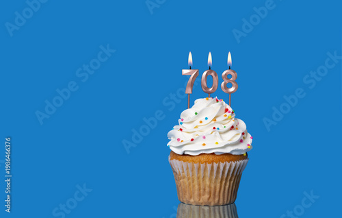 Birthday Or Anniversary Cupcake With Lit Candles; Candles Forming The Number 708