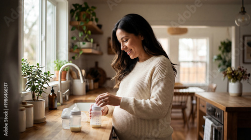 Pregnant woman in kitchen preparing baby bottles expressing tender maternal care and hopeful preparation for parenting lifestyle magazine editorial photography