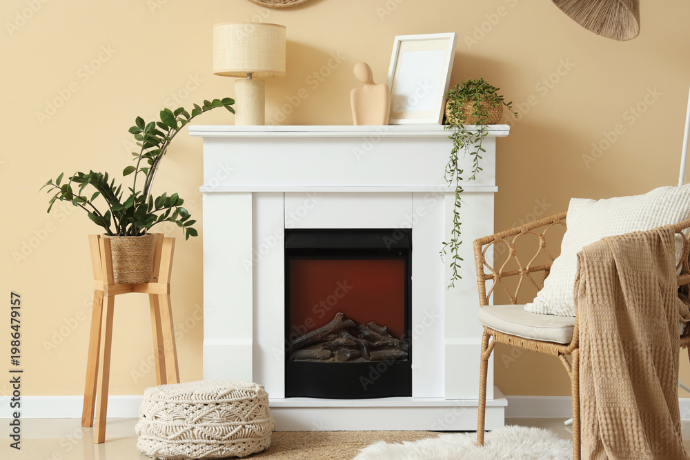 Fototapeta premium Fireplace, wicker chair and houseplants in interior of living room