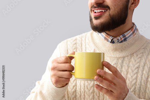 Young man with cup of tea o...