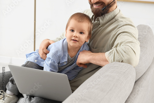 Working father with laptop ...