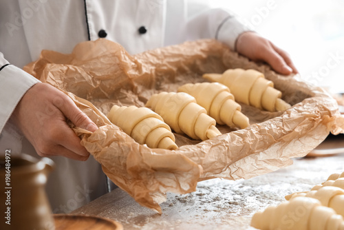 Female baker holding baking...