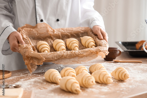 Female baker holding baking...