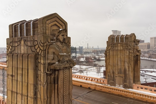 Art deco statues in winter with city skyline in the distance - Cleveland, Ohio