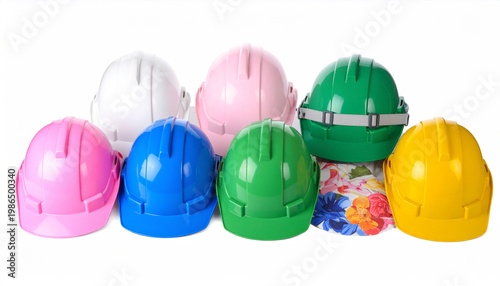 Assortment of colorful plastic safety helmets in pink blue green white and yellow on white