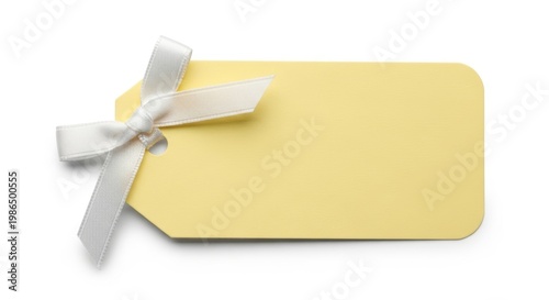 Elegant yellow gift tag with white ribbon and bow on isolated background