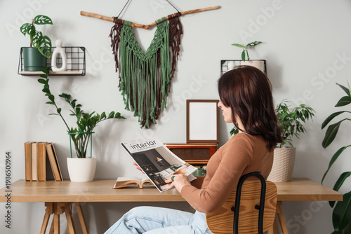 Young woman reading magazin...